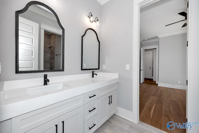 22938 Gunner Cir, Athens, AL 35613 - bathroom featuring double vanity, a ceiling fan, ornamental molding, baseboards, and tiled shower