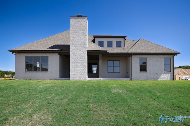 22938 Gunner Cir, Athens, AL 35613 - rear view of house with brick siding, a chimney, a lawn, and a shingled roof