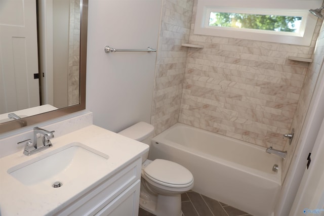 full bathroom featuring tiled shower / bath combo, tile patterned floors, toilet, and vanity