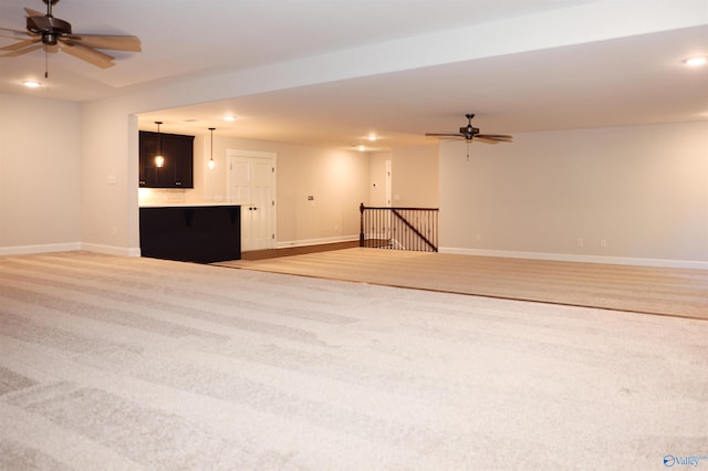 interior space featuring light colored carpet and ceiling fan