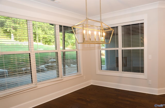 unfurnished dining area with a notable chandelier and dark hardwood / wood-style flooring