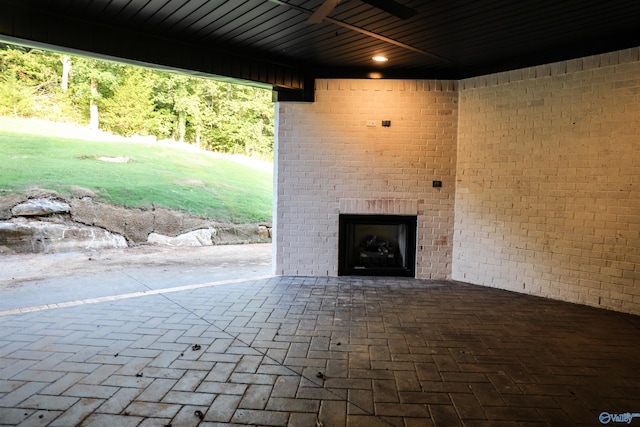 view of patio / terrace featuring an outdoor brick fireplace