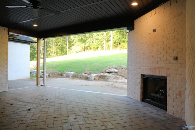 view of patio featuring exterior fireplace and ceiling fan