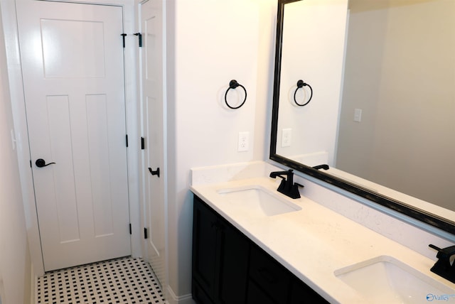 bathroom with dual vanity and tile patterned floors