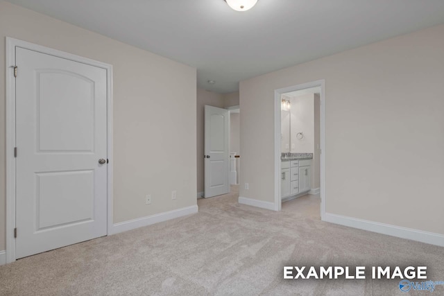 unfurnished bedroom with connected bathroom and light colored carpet