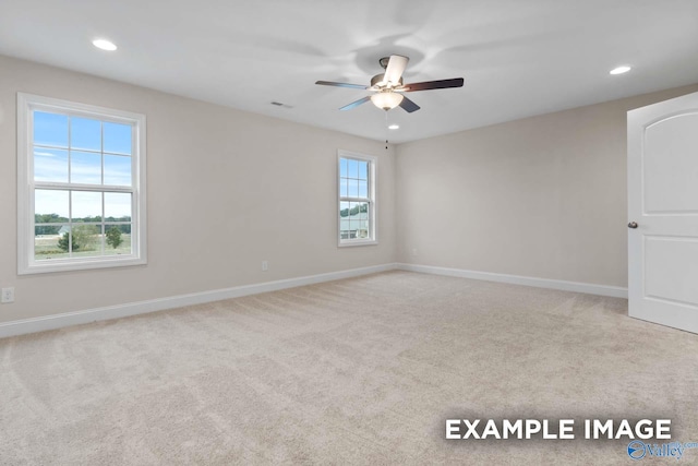 spare room with light carpet and ceiling fan