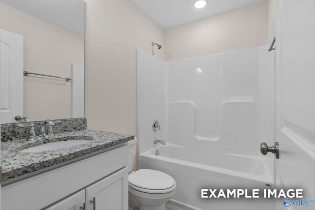 full bathroom with vanity, shower / tub combination, and toilet