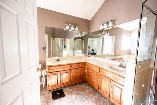 full bath featuring lofted ceiling, a stall shower, double vanity, and a sink