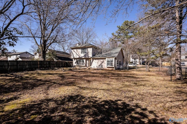 back of property featuring fence