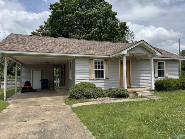 1206 Fulton St, Albertville, AL 35950 - single story home with concrete driveway, roof with shingles, a front lawn, and an attached carport