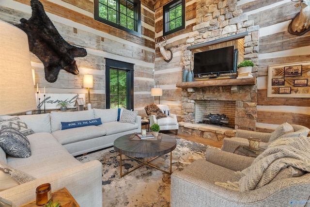 511 Pine Island Cir, Scottsboro, AL 35769 - living area featuring a fireplace, a towering ceiling, wood walls, and wood finished floors