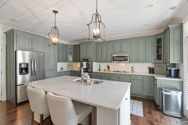 511 Pine Island Cir, Scottsboro, AL 35769 - kitchen with stainless steel appliances, green cabinets, dark wood-style floors, an island with sink, and hanging light fixtures