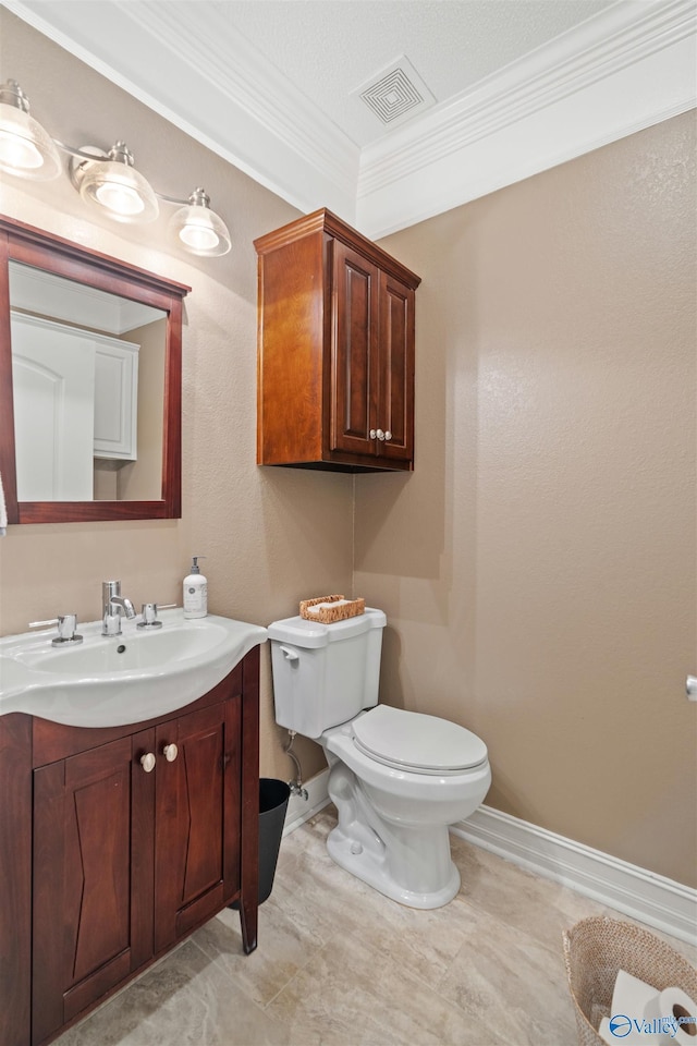 511 Pine Island Cir, Scottsboro, AL 35769 - bathroom with crown molding, toilet, baseboards, and vanity