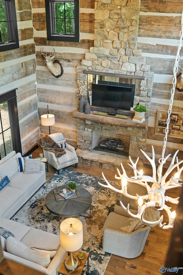 511 Pine Island Cir, Scottsboro, AL 35769 - living room featuring a stone fireplace, wooden walls, and wood finished floors