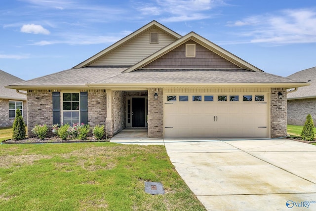 view of front of property with a front lawn and a garage