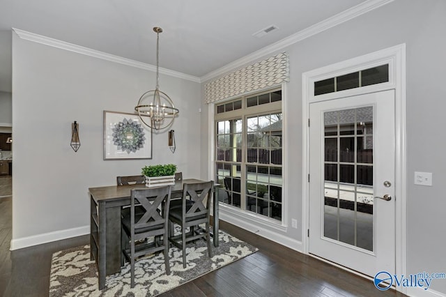 dining space with ornamental molding, dark hardwood / wood-style floors, and an inviting chandelier