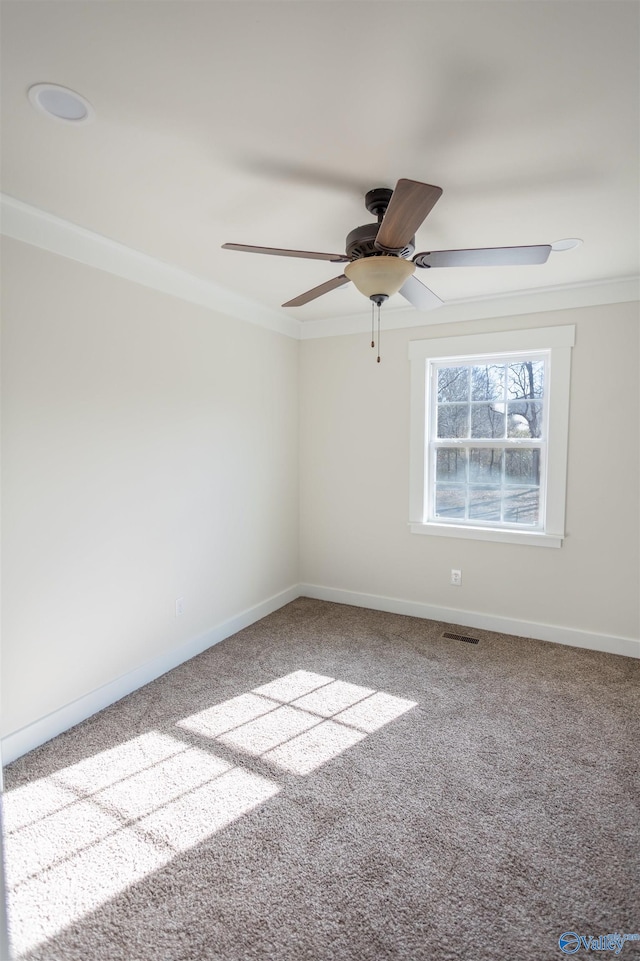 empty room with carpet floors, ceiling fan, and crown molding