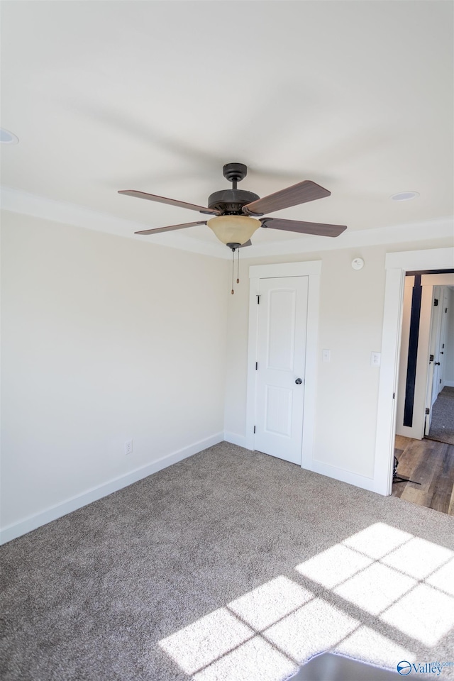 unfurnished bedroom featuring carpet floors and ceiling fan