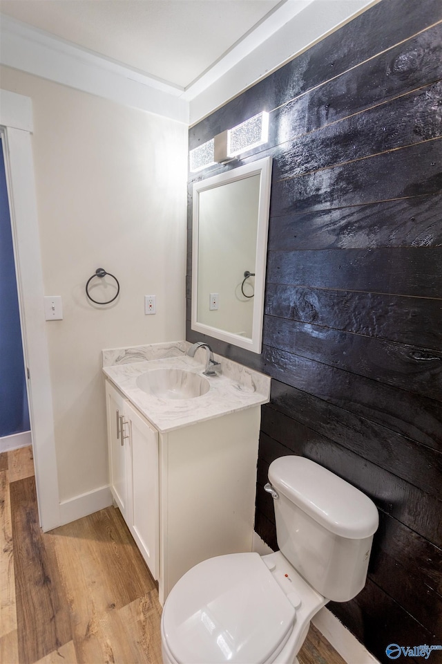 bathroom with vanity, hardwood / wood-style flooring, and toilet