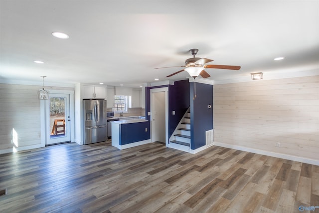 kitchen with appliances with stainless steel finishes, ceiling fan, white cabinets, and dark wood-type flooring