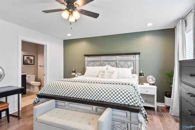 bedroom with connected bathroom, wood-type flooring, and ceiling fan