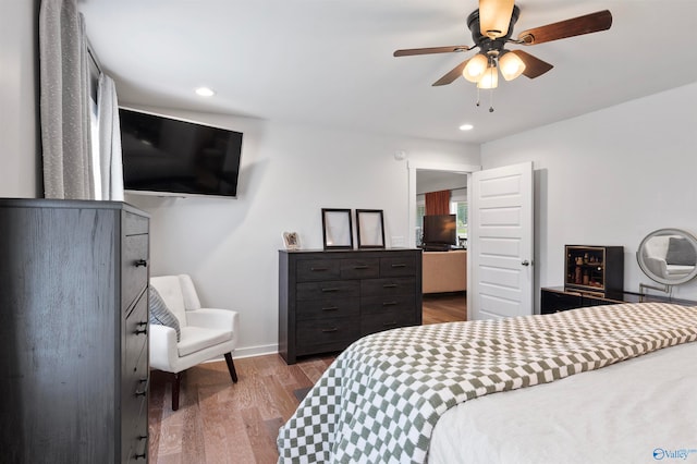 bedroom with wood-type flooring and ceiling fan