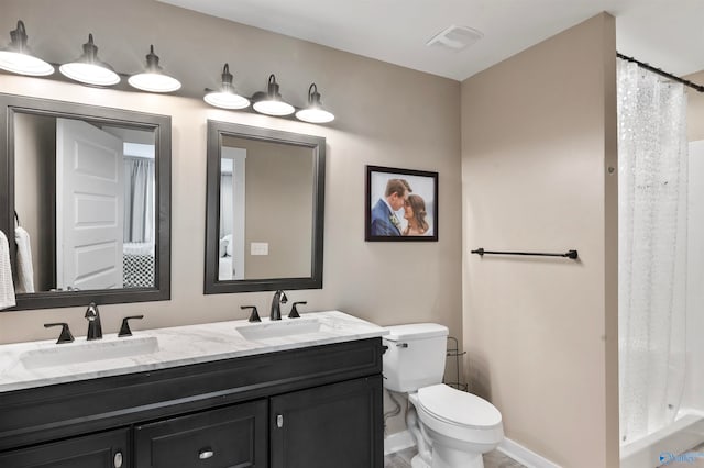 bathroom featuring toilet, a shower with curtain, and vanity