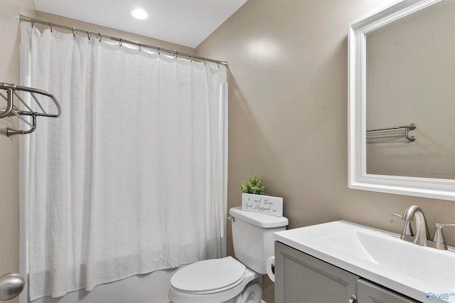 full bathroom featuring toilet, shower / bath combo, and vanity