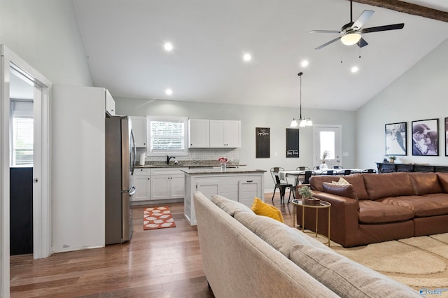 living room featuring hardwood / wood-style flooring, sink, and plenty of natural light