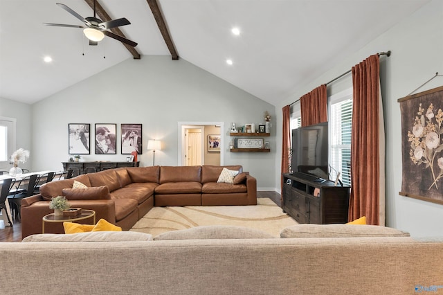 living room featuring beam ceiling, hardwood / wood-style flooring, high vaulted ceiling, and ceiling fan