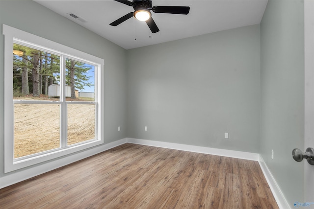 spare room featuring wood-type flooring and ceiling fan