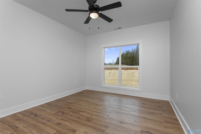 spare room featuring wood-type flooring and ceiling fan