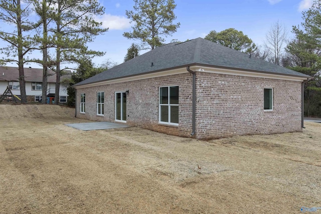 back of house featuring a patio and a lawn