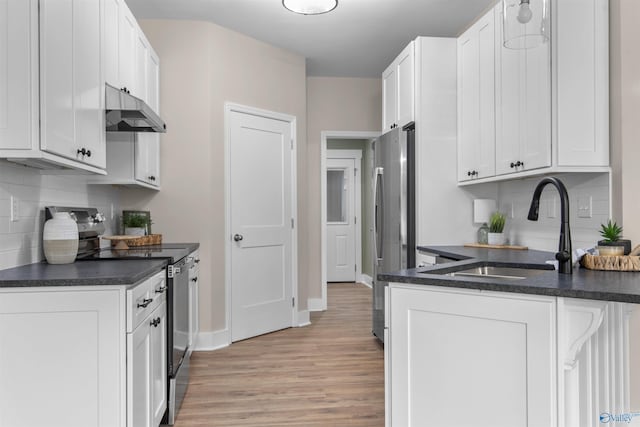 kitchen featuring white cabinetry, sink, light hardwood / wood-style flooring, and stainless steel appliances