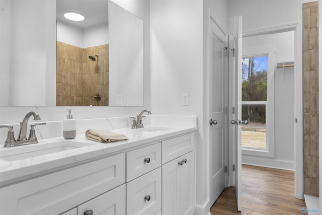 bathroom featuring vanity, tiled shower, and hardwood / wood-style floors