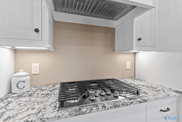 23784 Old Homeplace Way, Athens, AL 35613 - kitchen view of stainless steel gas cooktop, custom range hood, white cabinetry, and light stone countertops