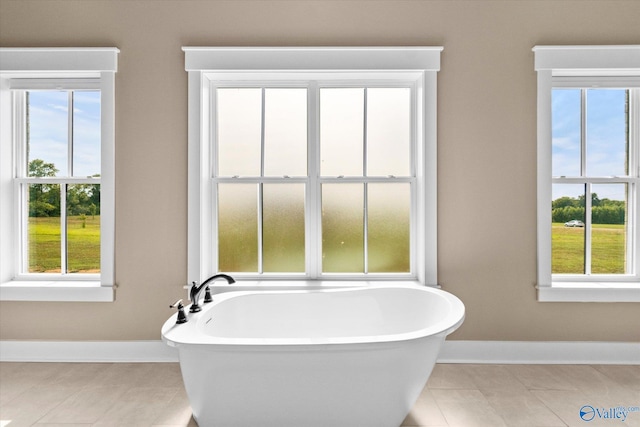 23784 Old Homeplace Way, Athens, AL 35613 - bathroom with baseboards, a freestanding tub, and tile patterned floors