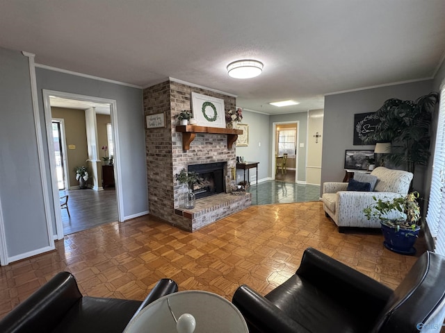 living room featuring a brick fireplace, crown molding, and baseboards