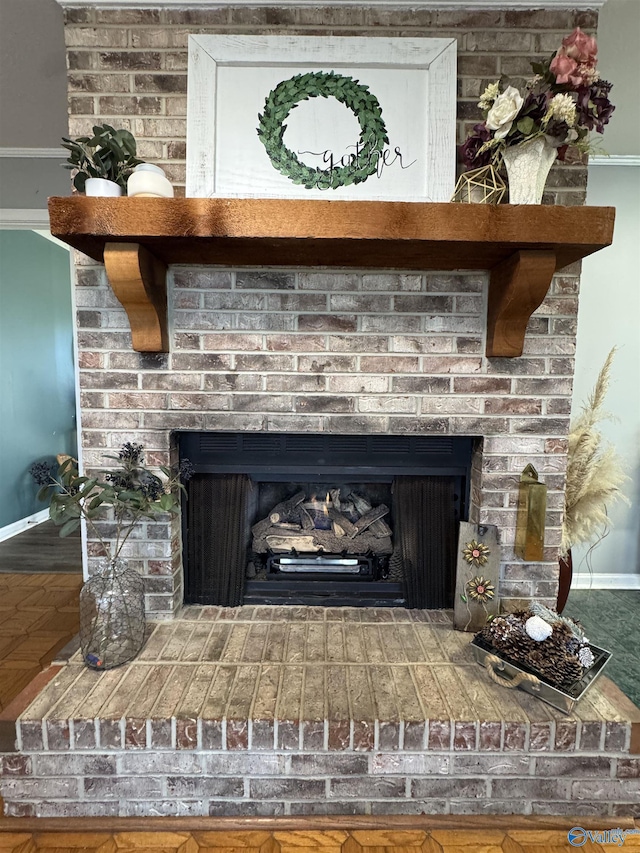 interior details featuring a brick fireplace and baseboards