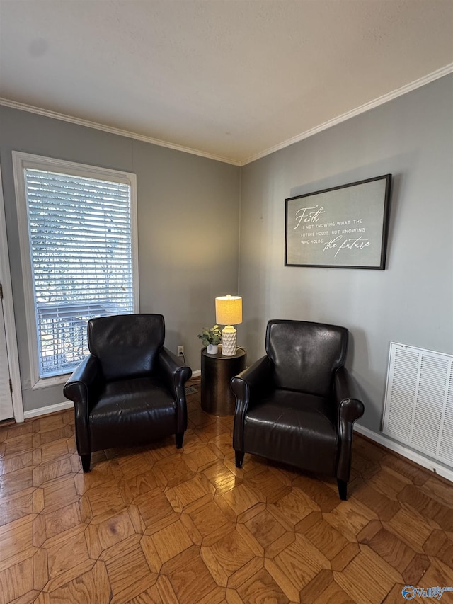 sitting room featuring baseboards, visible vents, and crown molding