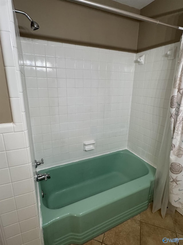 bathroom featuring shower / bath combo with shower curtain and tile patterned floors