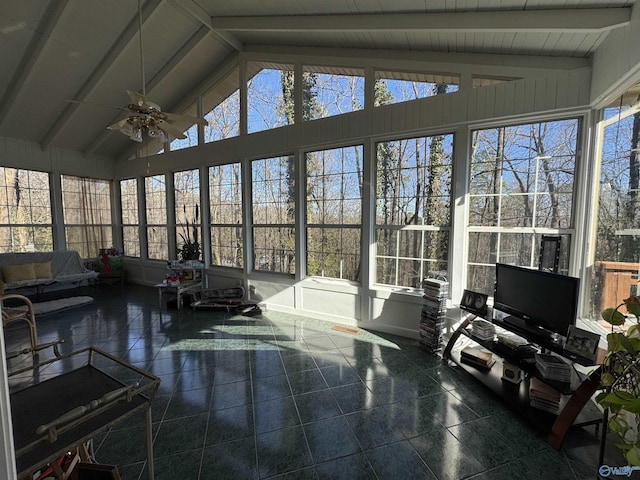 sunroom with lofted ceiling with beams, ceiling fan, and a wealth of natural light