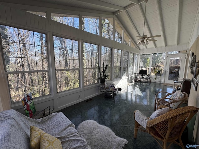 sunroom with lofted ceiling with beams, ceiling fan, and visible vents