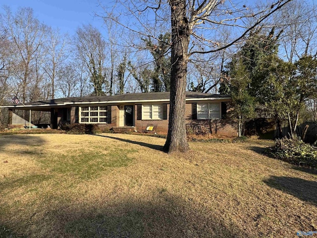 single story home featuring a front yard and brick siding