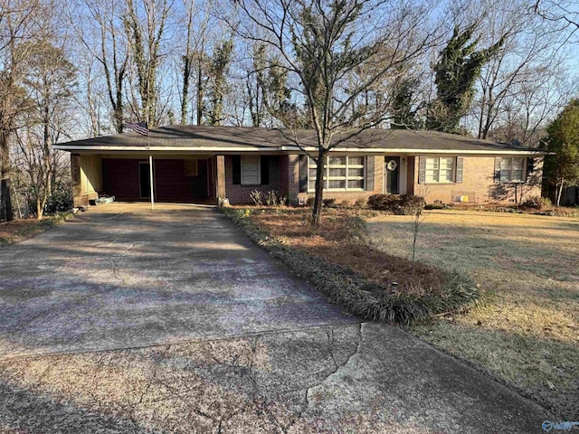 ranch-style house featuring aphalt driveway, a front lawn, and brick siding