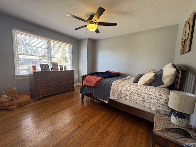 bedroom featuring a ceiling fan and wood-type flooring