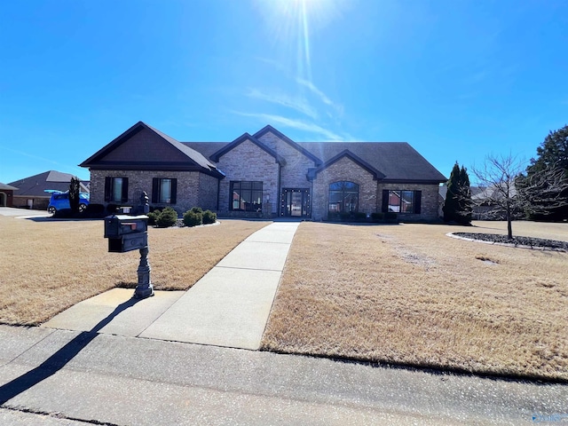 view of front of property with a front lawn and brick siding