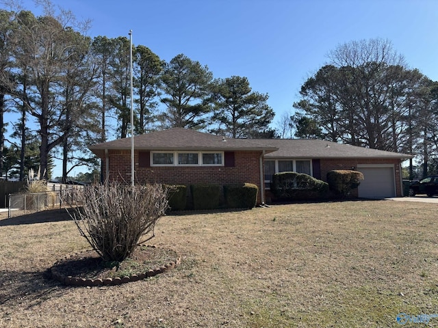 ranch-style house with a garage, brick siding, fence, and a front lawn