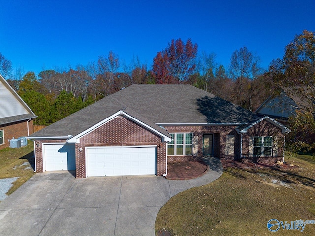 single story home featuring a garage and a front lawn