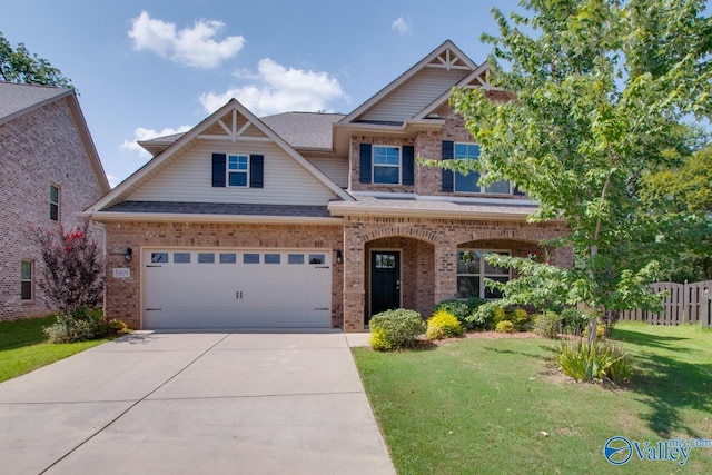 craftsman house with a garage and a front lawn